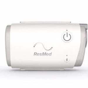A white resmed cpap machine with the side of it open.